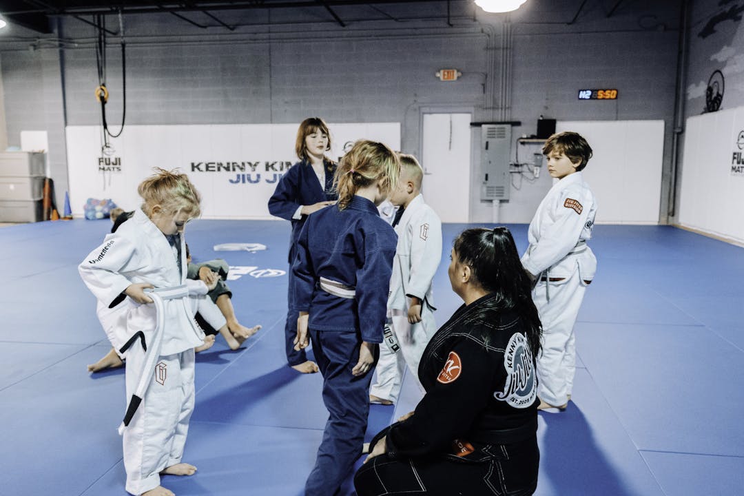 Brazilian Jiu Jitsu Kids at Kenny Kim BJJ in Marietta GA in class circled around their instructor 