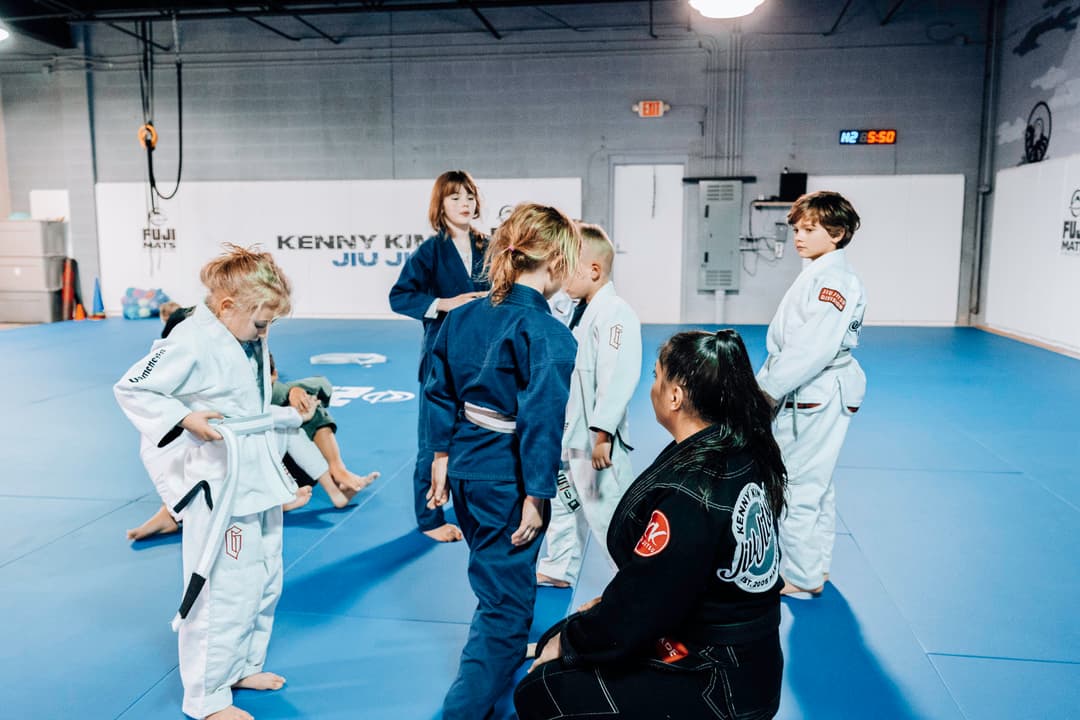 Brazilian Jiu Jitsu Kids at Kenny Kim BJJ in Marietta GA in class circled around their instructor