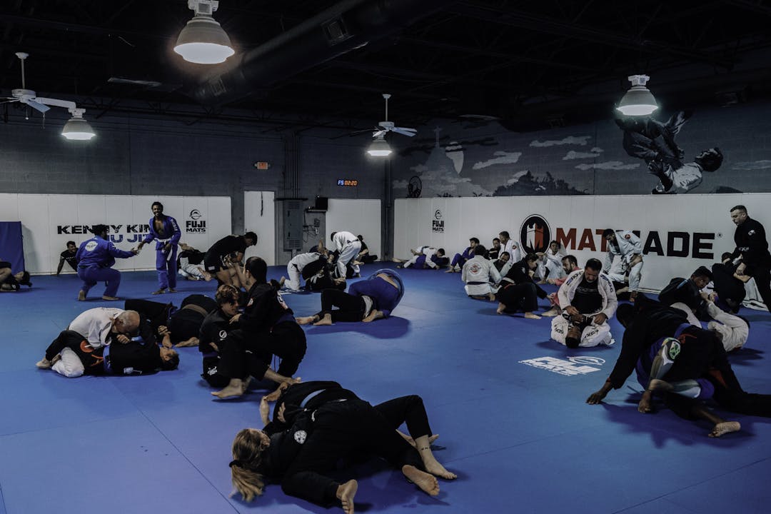 Groups of Adult Brazilian Jiu Jitsu Students at Kenny Kim BJJ in Marietta GA  rolling on the mats during an awesome training session