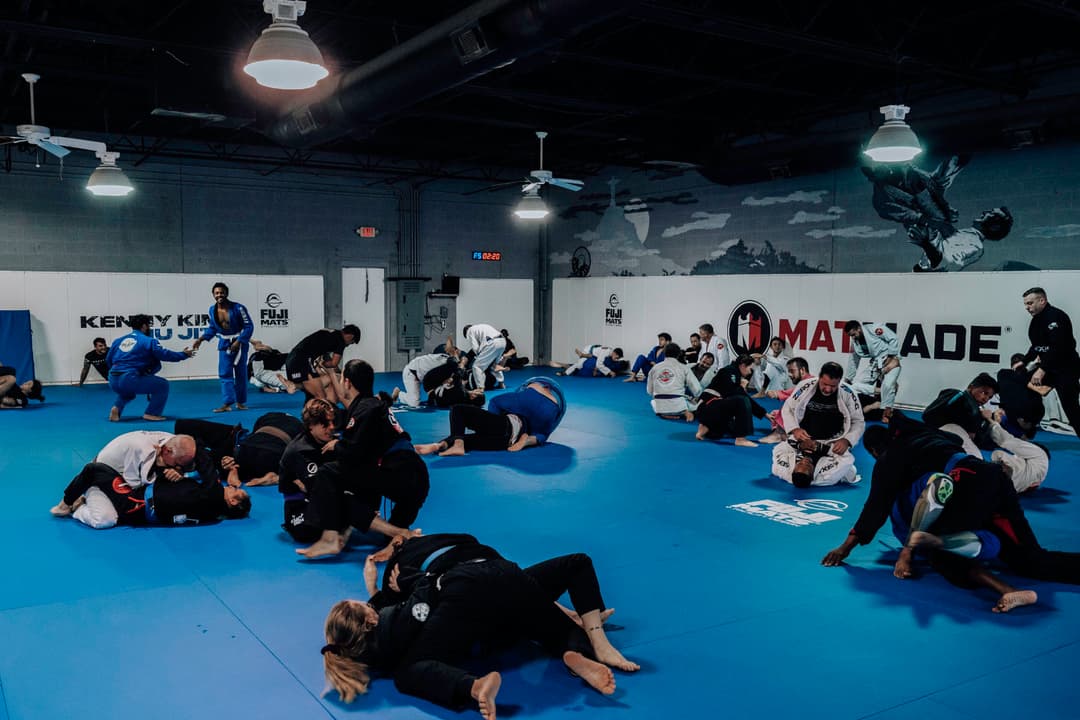 Groups of Adult Brazilian Jiu Jitsu Students at Kenny Kim BJJ in Marietta GA rolling on the mats during an awesome training session