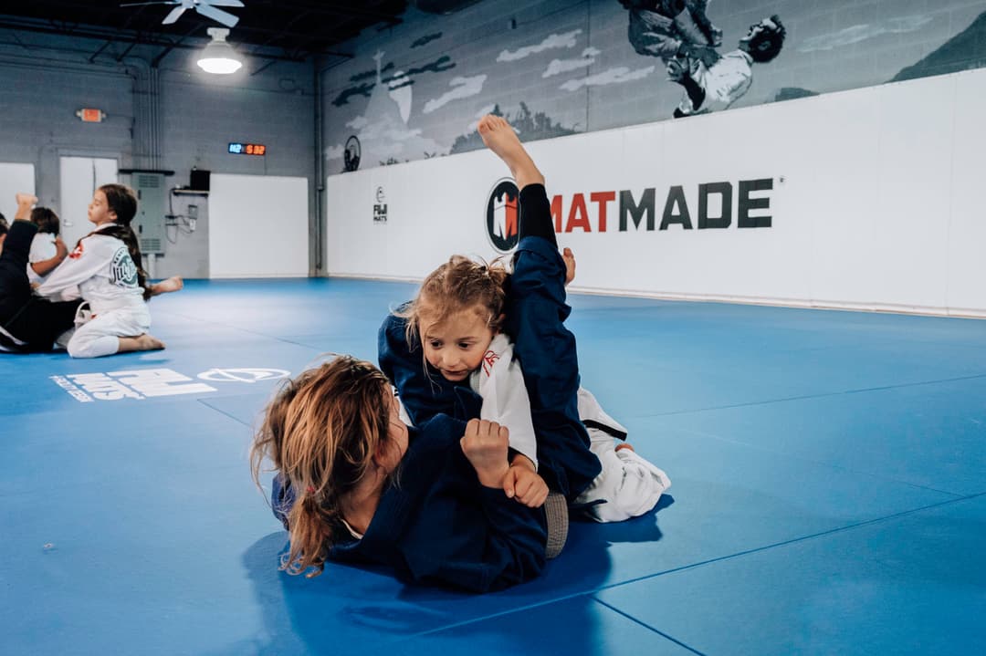 Brazilian Jiu Jitsu Kids at Kenny Kim BJJ in Marietta GA rolling on the mats