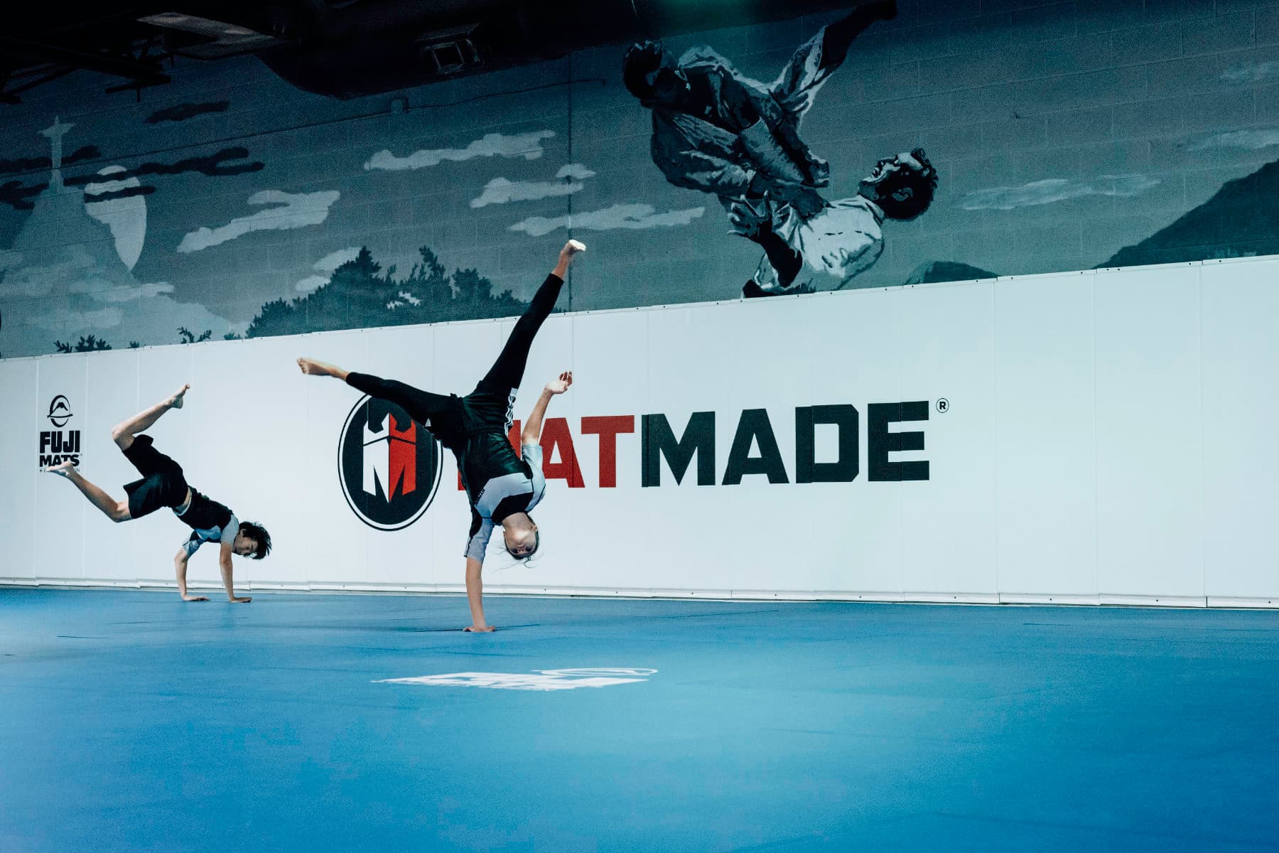 Brazilian Jiu Jitsu Teenagers at Kenny Kim BJJ in Marietta GA warming up doing cartwheels